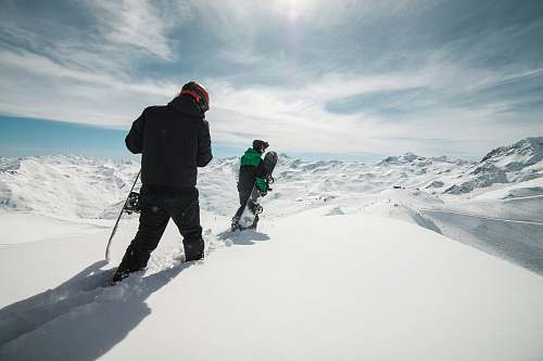 les menuires two people carrying snowboards on snow covered terrain snow